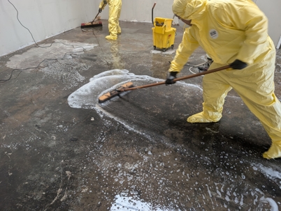ABC Restoration Employee Scrubs Floors